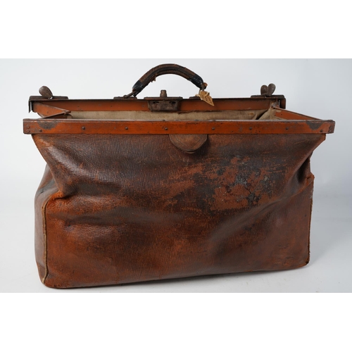 368 - An antique gladstone leather medical bag.