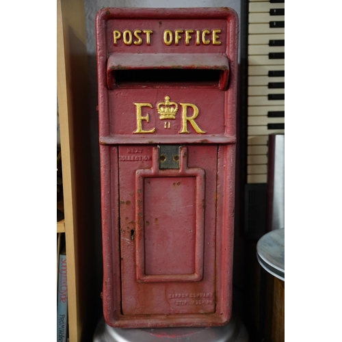 A vintage cast iron Post Office letterbox, reading 'Post Office - E R'.