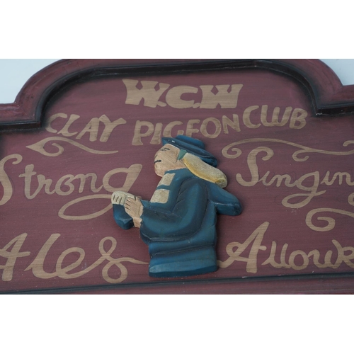 379 - An antique style wooden plaque for 'W.C.W Clay Pigeon Club', measuring 45cm x 37cm.