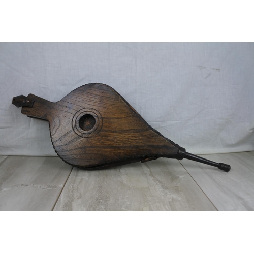 402 - An antique oak fire bellow.