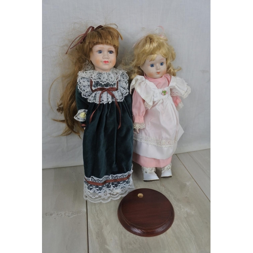 407 - Two ceramic faced collectors dolls and stand.