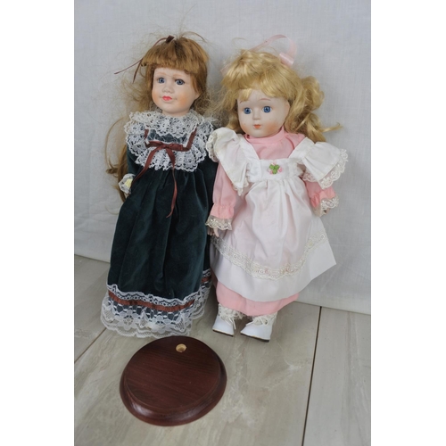 407 - Two ceramic faced collectors dolls and stand.