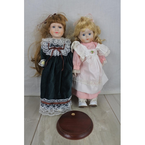 407 - Two ceramic faced collectors dolls and stand.