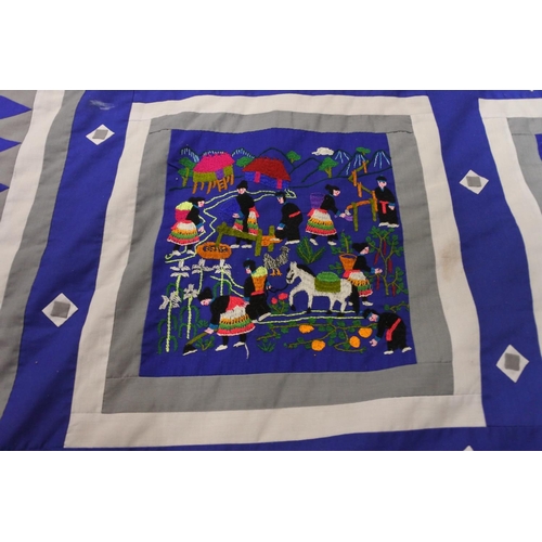 416 - A stunning patterned quilt with embroidery detail.