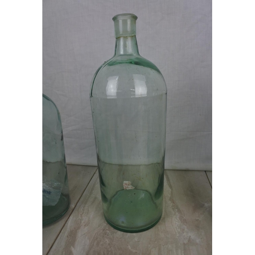 417 - Three large clear glass bottles and more.