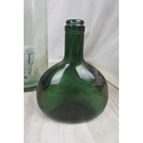 417 - Three large clear glass bottles and more.