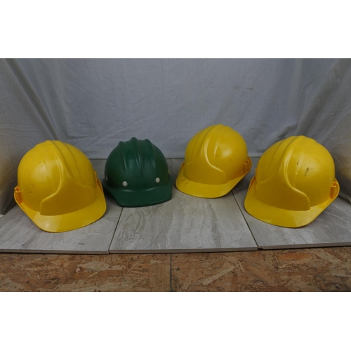 424 - Three JSP hard hats and another.