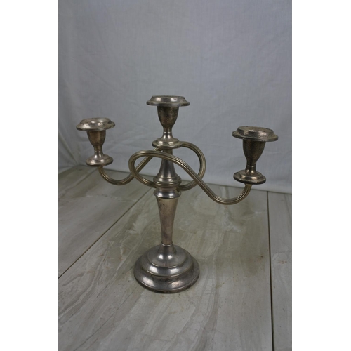 427 - A three branch silver plated candelabra.