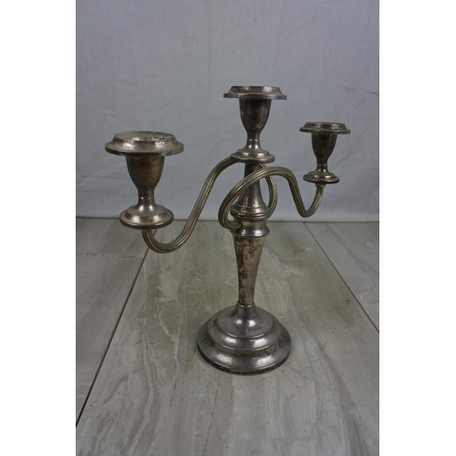 427 - A three branch silver plated candelabra.