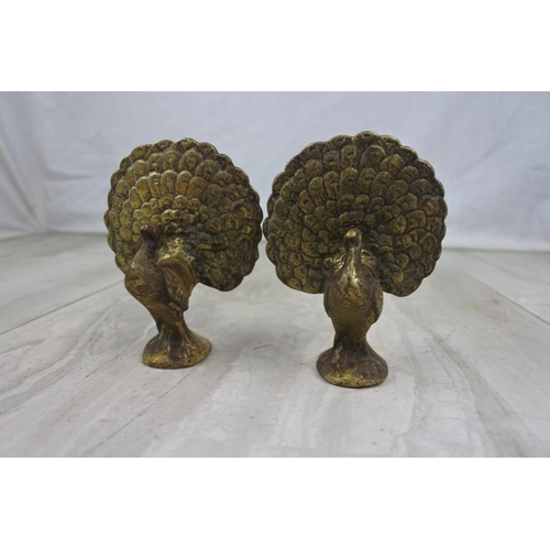 429 - A pair of vintage brass peacock bird ornaments, measuring 10cm tall.