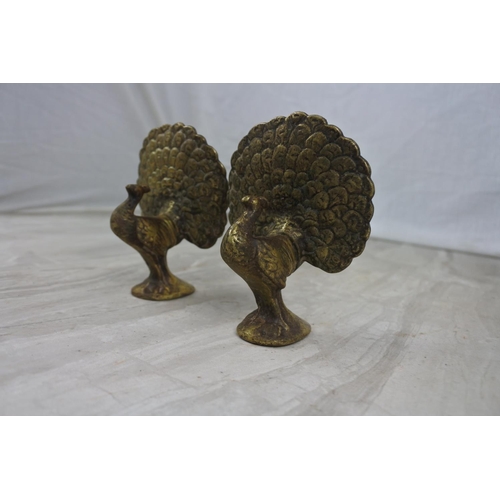 429 - A pair of vintage brass peacock bird ornaments, measuring 10cm tall.