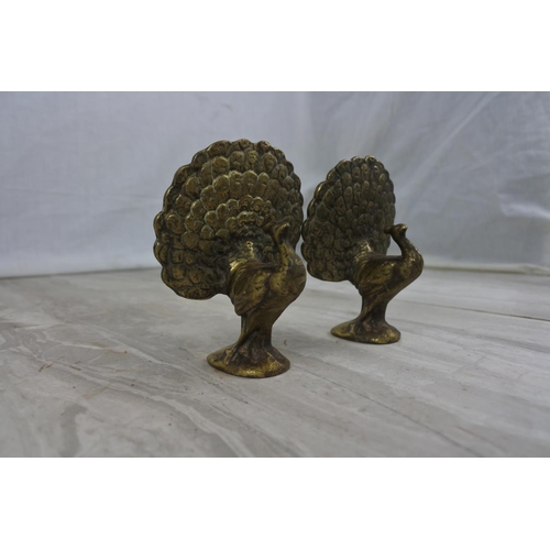 429 - A pair of vintage brass peacock bird ornaments, measuring 10cm tall.