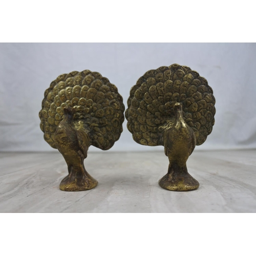 429 - A pair of vintage brass peacock bird ornaments, measuring 10cm tall.