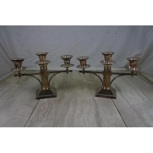 438 - A stunning pair of silver plated column candelabra's, measuring 19cm tall.