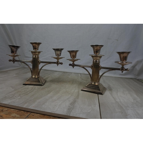 438 - A stunning pair of silver plated column candelabra's, measuring 19cm tall.