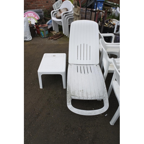 755 - A plastic garden sun lounger and matching table.