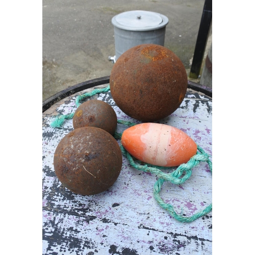 764 - Three metal balls and a fishing float.