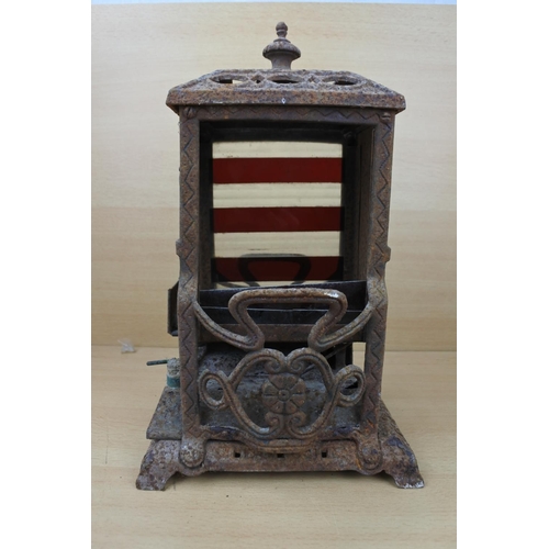 1183 - An antique Wright & Butler stove with a coloured panel stove. (a/f)