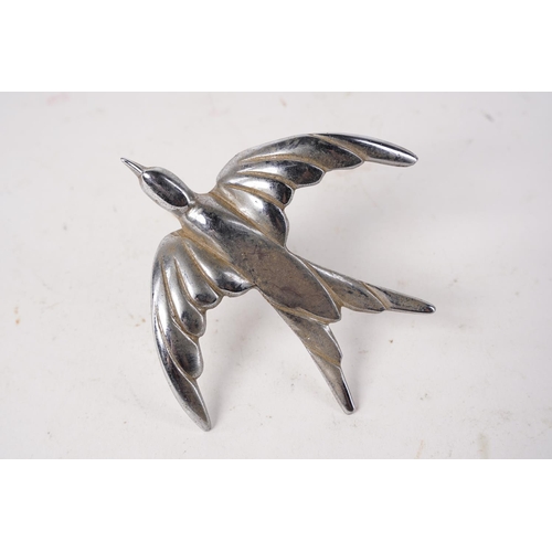 586 - A metal bird in flight.