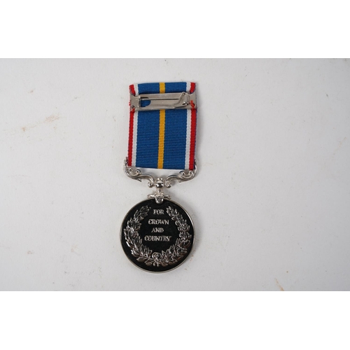 682 - A National Service Medal, engraved to rim, ' G.E Cudd'.