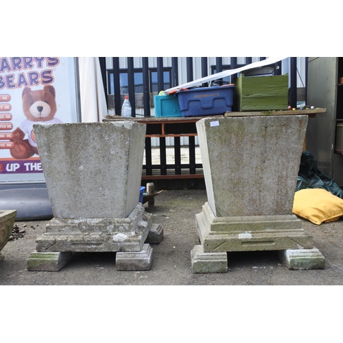 770 - A large pair of concrete planters on a plinth base and feet, measuring 27