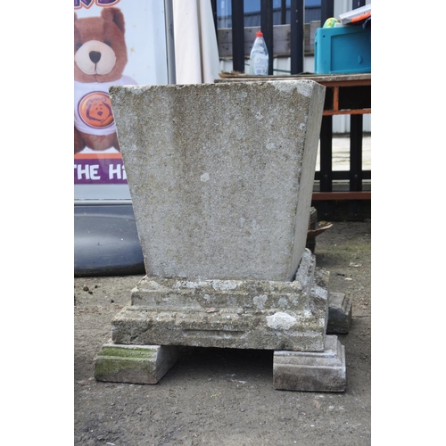 770 - A large pair of concrete planters on a plinth base and feet, measuring 27