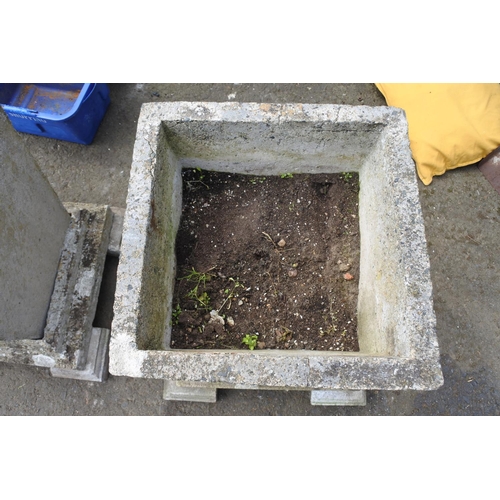 770 - A large pair of concrete planters on a plinth base and feet, measuring 27