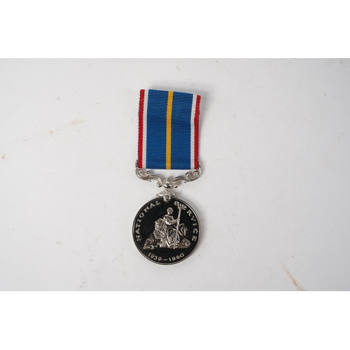 682 - A National Service Medal, engraved to rim, ' G.E Cudd'.