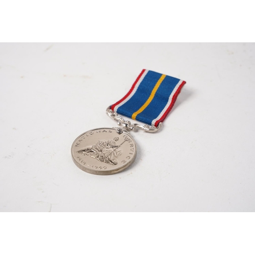 682 - A National Service Medal, engraved to rim, ' G.E Cudd'.