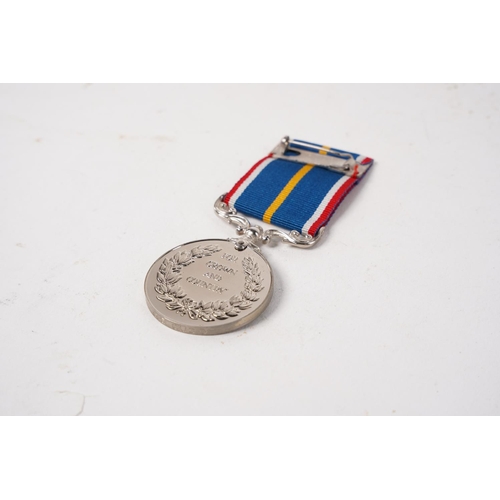 682 - A National Service Medal, engraved to rim, ' G.E Cudd'.