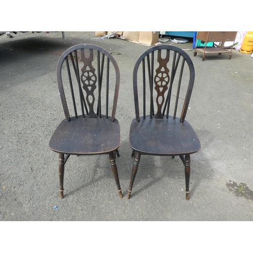 785 - A pair of Vintage stained wooden dining chairs.