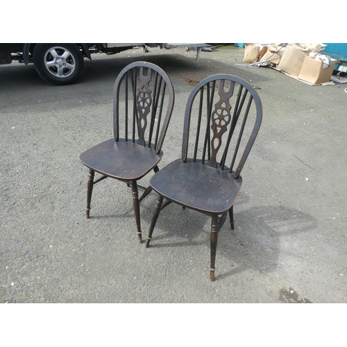 785 - A pair of Vintage stained wooden dining chairs.