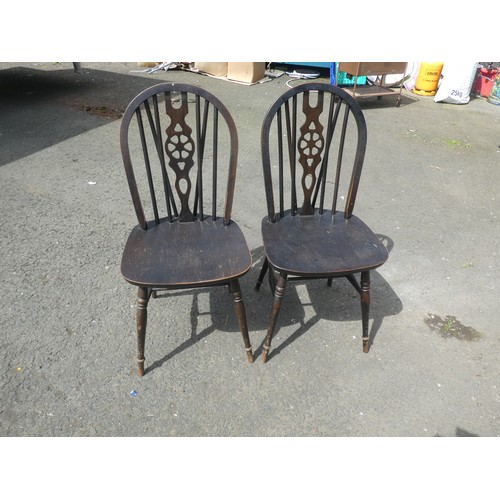 785 - A pair of Vintage stained wooden dining chairs.