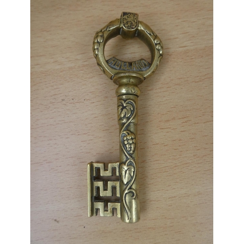 11 - A 'Holland' brass ornamental key.