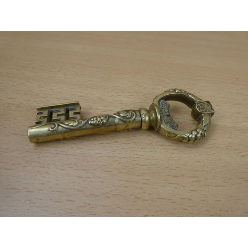 11 - A 'Holland' brass ornamental key.