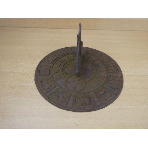 15 - A cast iron sundial with ship detail, measuring 26cm in diameter.