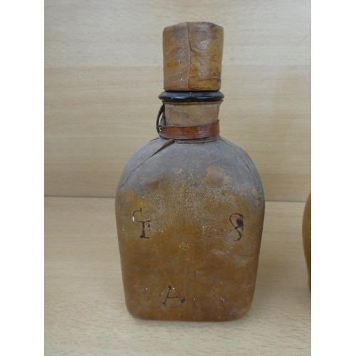 20 - Two Spanish leather covered bottles.