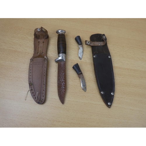 31 - A metal dagger and sheath and two miniature knives and sheath.