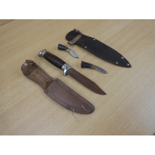 31 - A metal dagger and sheath and two miniature knives and sheath.