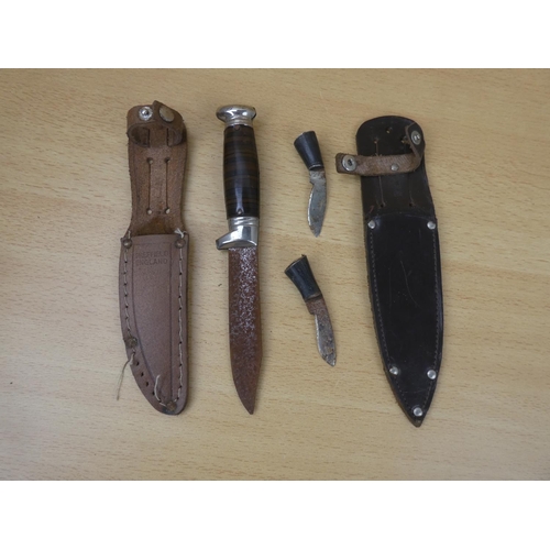 31 - A metal dagger and sheath and two miniature knives and sheath.