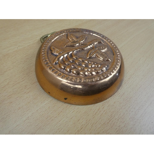 56 - A small copper and brass gilt wall plaque.