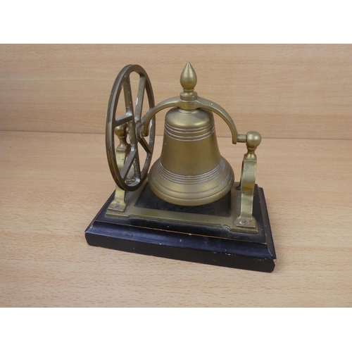 71 - A vintage brass mounted bell on stand.