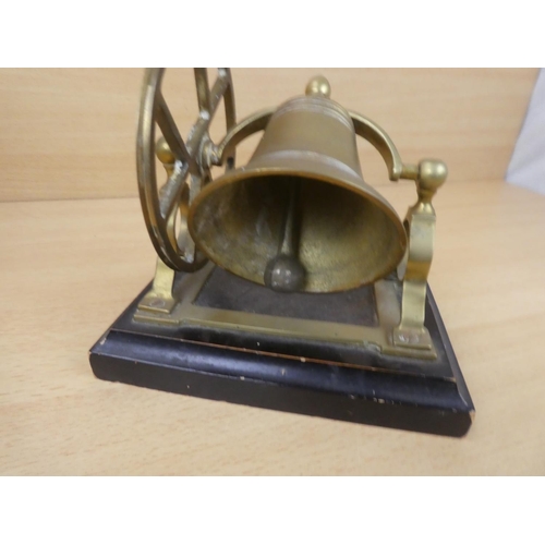 71 - A vintage brass mounted bell on stand.