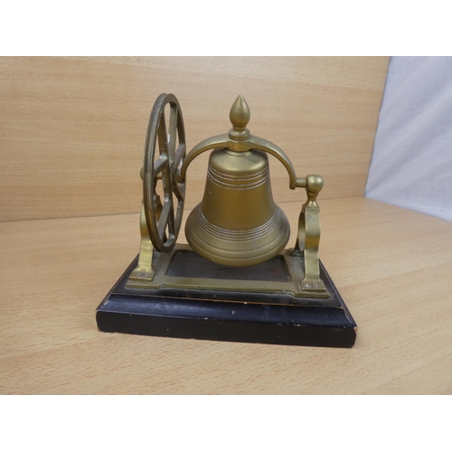 71 - A vintage brass mounted bell on stand.