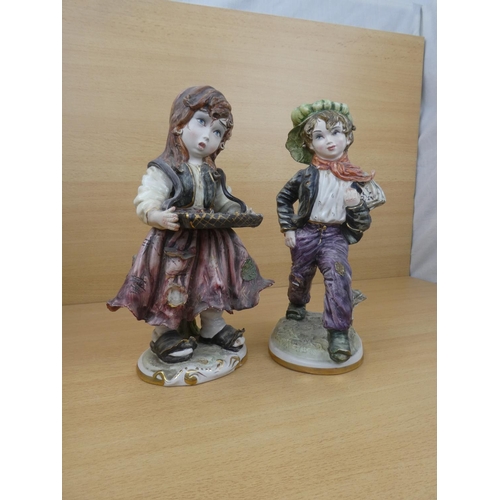 72 - A pair of Capodimonte style figures, each measuring 30cm in height.