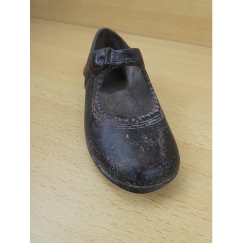 85 - An antique cast metal child's shoe.