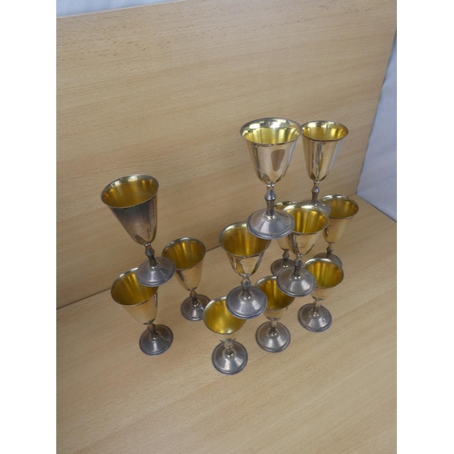 90 - Two sets of six silverplated and gilt goblets.