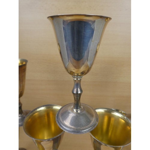 90 - Two sets of six silverplated and gilt goblets.