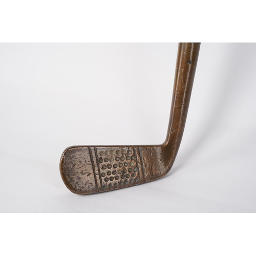 4 - An antique U Kendall brass head golf club.