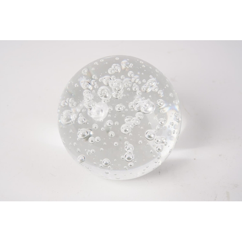 87 - A large glass paperweight, measuring 10cm x 10cm.